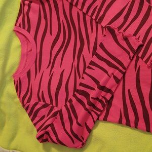 Girl's top pink with black stripes.